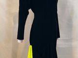 the dress is black and yellow and has a long sleeve
