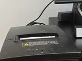 a desktop computer sitting on top of a printer on a desk