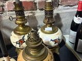 bottles of wine are sitting on a table next to a lamp