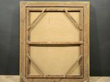 an old wooden frame with a brown canvas on a wooden floor