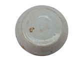 a white bowl with a brown spot on it