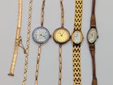 many different types of watches and bracelets on the table