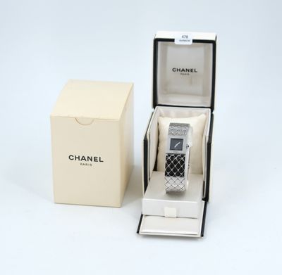 an image of a watch in a box on a white surface