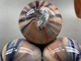 three blue and brown vases stacked on top of each other