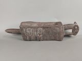 an image of a stone object with a handle on a white surface