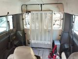 a view of the inside of a bus with the door open