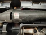 a small electric drill in a box with other tools in it
