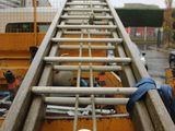 an image of a ladder going up to the top of a building