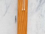 a close up of a wooden stick with a white string on it