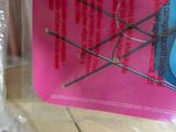 a package of sewing needles sitting on top of a plastic bag