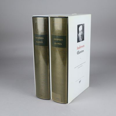 two books are sitting on top of each other in front of a white box