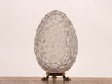 an image of a glass egg on a wooden table
