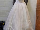 a dress hanging on a mannequin in a room