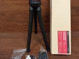 a tripod sitting on a wooden table next to a box