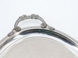 a silver plate with a handle on it on a table