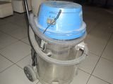 a vacuum cleaner sitting on a tiled floor in a living room
