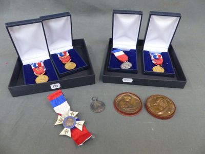 two medals and a medal are sitting on a table