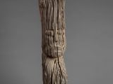 an image of a piece of wood with a face carved into it