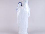 a white and blue vase with a bird on it