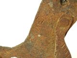 a rusted metal object with a bird on top of it