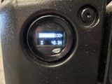 a close up view of a digital clock on a motorcycle