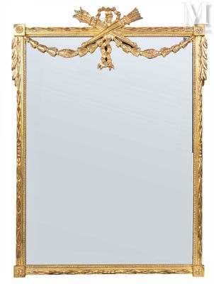a gold framed mirror with a decorative design on it