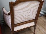 a chair with a zebra print upholstered on the back of it