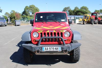 a red jeep that is parked in a parking lot