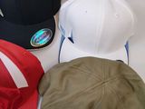 several different hats are lined up on a white surface