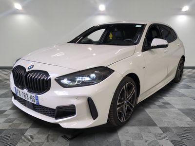 the white bmw m140i sports wagon is parked in a showroom