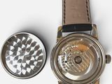 a watch that is sitting next to a metal object