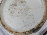 a dirty plate sitting on top of a stove