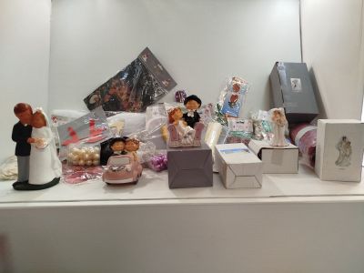 a display of wedding figurines on a shelf in a room