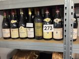 many bottles of wine sitting on a shelf in a store