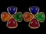 a pair of multicolored earrings on a black background