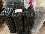 a pile of black rods sitting on the floor