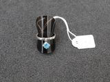 a ring with a blue stone on it sitting on a table