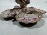 two small dishes with flowers on them sitting on a table