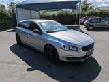 the silver car is parked in the parking lot under a canopy