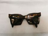 pair of black and tortoise sunglasses on a white surface