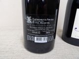 a bottle of wine next to a bottle of wine on a table