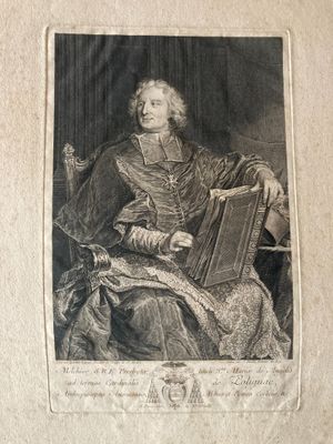 an old black and white photo of a man sitting in a chair holding a book