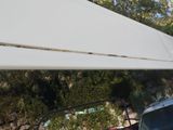 a car that is parked under a white awning