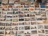 a lot of old postcards on the table