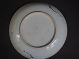 a white plate with blue designs on it on a table