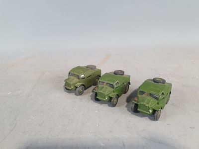 four toy army vehicles that are sitting on the ground