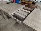 a wooden table with a drawer underneath it in a room