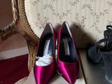 two pairs of shoes sitting on a box next to a chair
