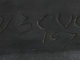 a close up of a statue of a dog with a name engraved on it