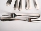 a lot of forks and spoons that are on the table